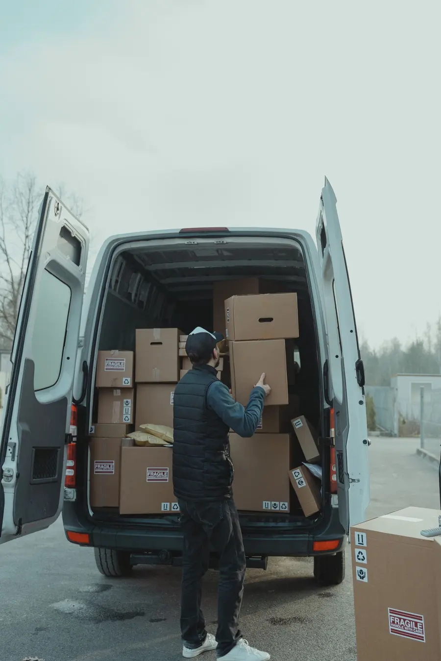 Courier driver securing goods inside a Ghile Trans Logistics van